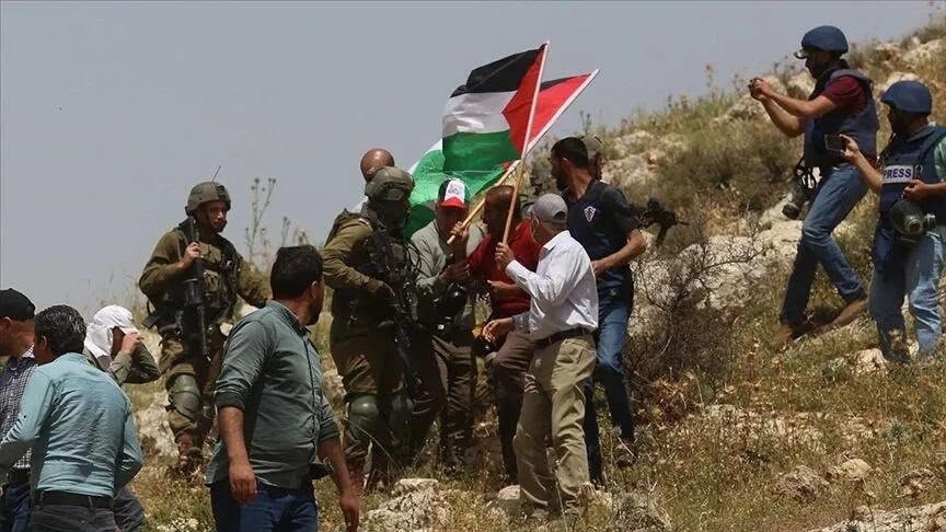 Palestinian flags raised during a documented civilian gathering